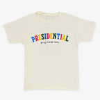 The Presidential Bring Change Home Youth T-Shirt is cream-colored and features "PRESIDENTIAL" in bold, colorful letters with "Bring Change Home" in smaller black text below.