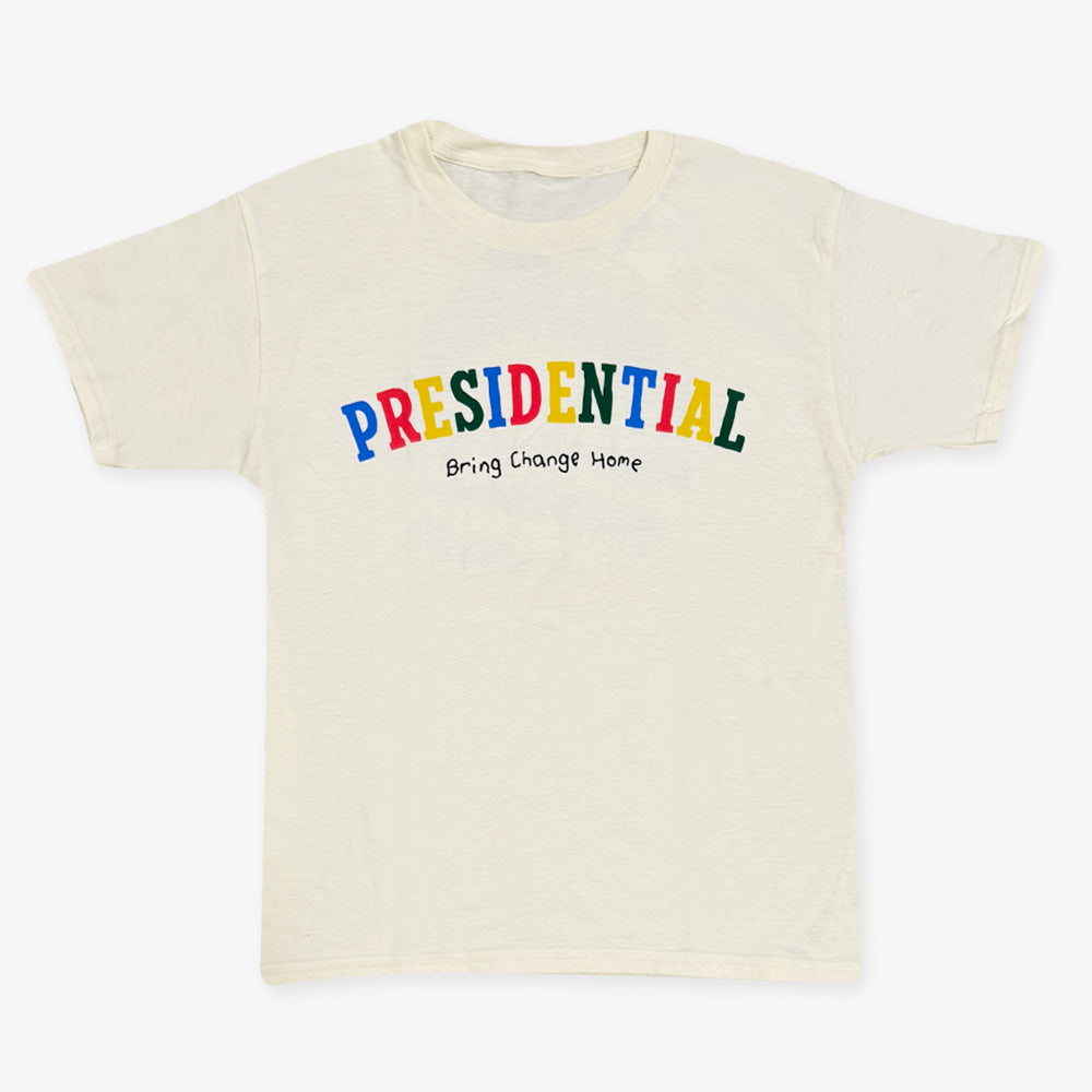 The Presidential Bring Change Home Youth T-Shirt is cream-colored and features "PRESIDENTIAL" in bold, colorful letters with "Bring Change Home" in smaller black text below.
