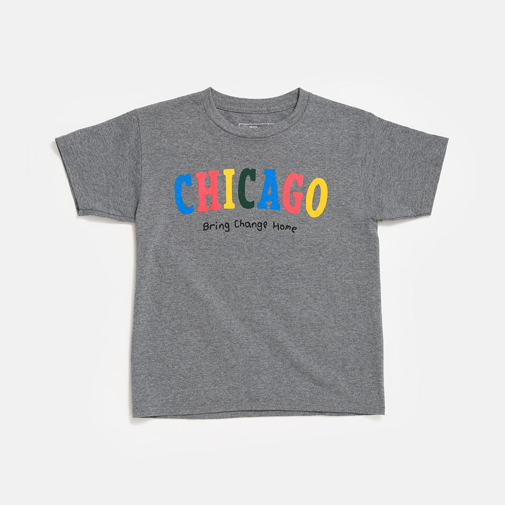 The Chicago Bring Change Home Youth T-Shirt is a gray short-sleeve shirt with “CHICAGO” in colorful, bold letters and “Bring Change Home” below, inspired by the Obama Foundation.