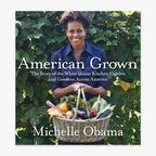 Michelle Obama stands before green foliage, smiling with a basket of vegetables. The cover displays the title: American Grown: The Story Of The White House Kitchen Garden And Gardens Across America.