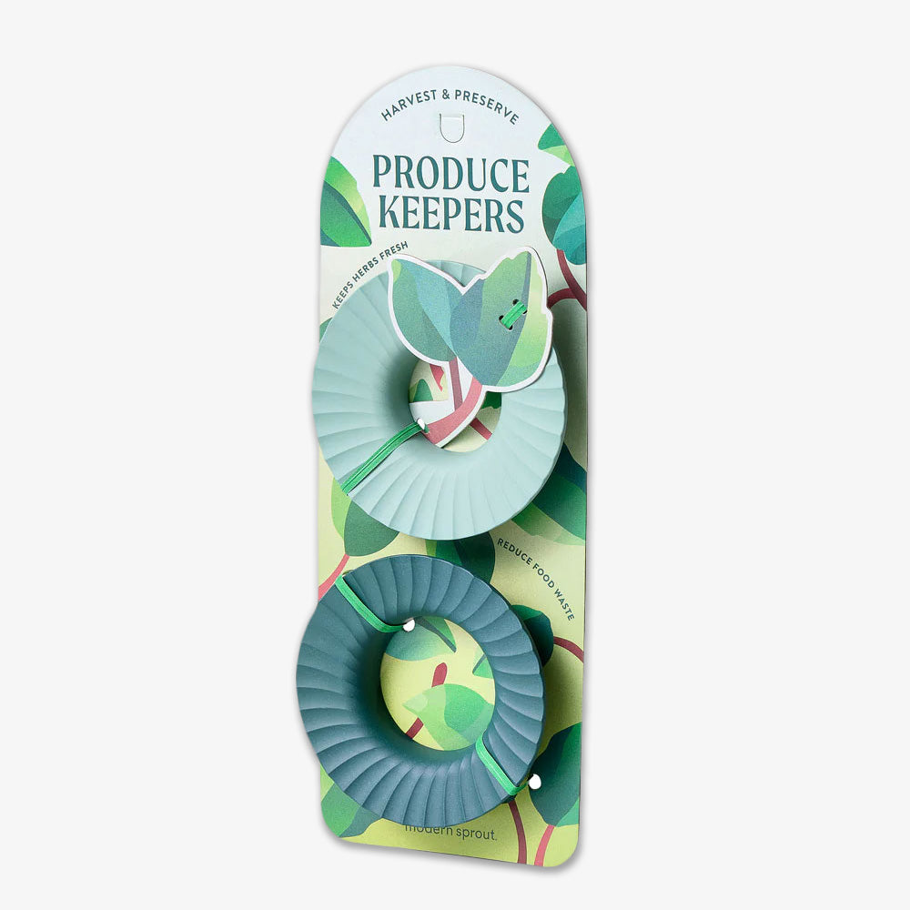 Two green, round Produce Keepers are attached to packaging labeled “HARVEST & PRESERVE PRODUCE KEEPERS” with leaf and plant designs—ideal for eco-friendly storage to keep produce fresh longer.