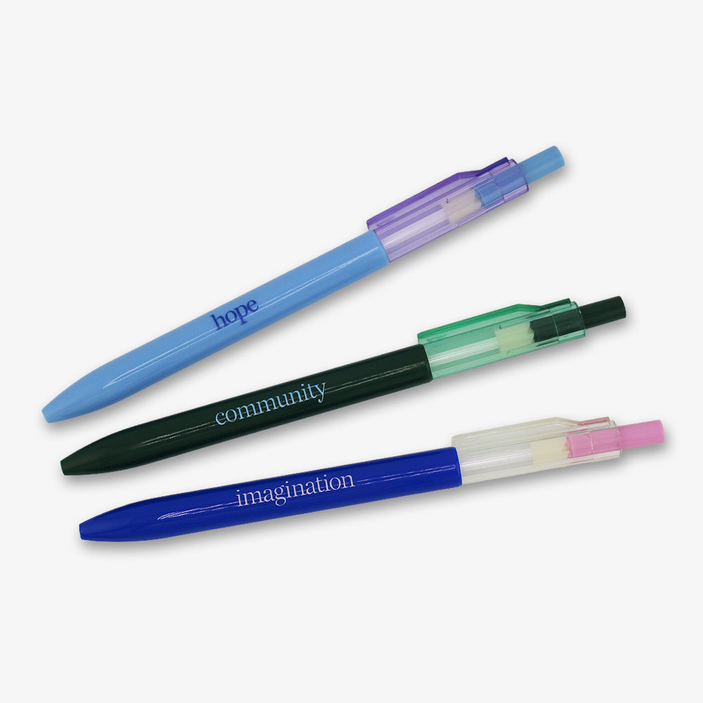 The Obama Presidential Center Pen Set features three pens—light blue (hope), black (community), and dark blue (imagination)—each with a translucent clip and colored push button, displayed diagonally on a white background.