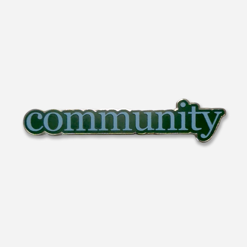 The Obama Presidential Center Community Magnet features “community” in bold, lowercase white letters outlined in green on a light gray background—an ideal keepsake or addition to your collection.