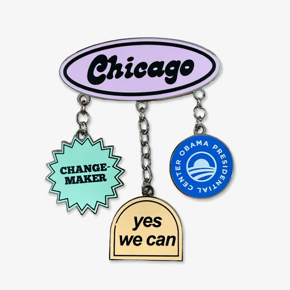 The Obama Presidential Center Stickers Dangle Magnet features a lavender oval labeled Chicago, with three hanging charms: a mint starburst reading CHANGE MAKER, a blue circle with Obama Presidential Center, and a yellow arch saying YES WE CAN.