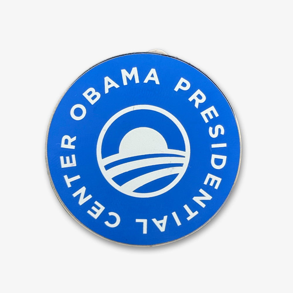 Show your support with the Obama Presidential Center Logo Magnet—a blue circular magnet featuring "OBAMA PRESIDENTIAL CENTER" around the edge and a rising sun over stripes logo. A unique keepsake for fans of the Obama Foundation or Chicago's South Side.