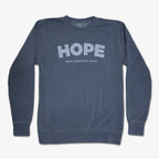 A black vintage crewneck Obama Presidential Center Hope Sweatshirt, featuring bold light "HOPE" lettering and "Obama Presidential Center" below. Classic style to show your support for the Obama Foundation.