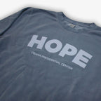 A black Obama Presidential Center Hope Sweatshirt with "HOPE" in large white letters above "OBAMA PRESIDENTIAL CENTER," inspired by vintage crewnecks and supporting the Obama Foundation.