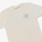 The Obama Presidential Center Hope to Action T-Shirt in ivory features an abstract circular logo with "Obama Presidential Center" text on the left chest for an inspirational look.