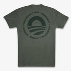 The Obama Presidential Center Hope to Action T-shirt is a dark gray tee with a circular logo of a stylized horizon, surrounded by the words: RESILIENCE • HOPE • COMMUNITY • COURAGE • EMPATHY • IMAGINATION, inspired by the Obama Foundation.