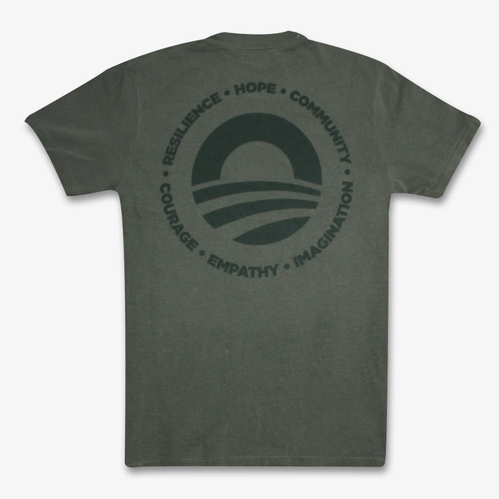 The Obama Presidential Center Hope to Action T-shirt is a dark gray tee with a circular logo of a stylized horizon, surrounded by the words: RESILIENCE • HOPE • COMMUNITY • COURAGE • EMPATHY • IMAGINATION, inspired by the Obama Foundation.