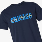 The Obama Presidential Center Chicago Script T-Shirt is a navy blue shirt showcasing “CHICAGO” in bold blue block letters and “Bring Change Home” in yellow script across the chest, inspired by the mission of the Obama Foundation.