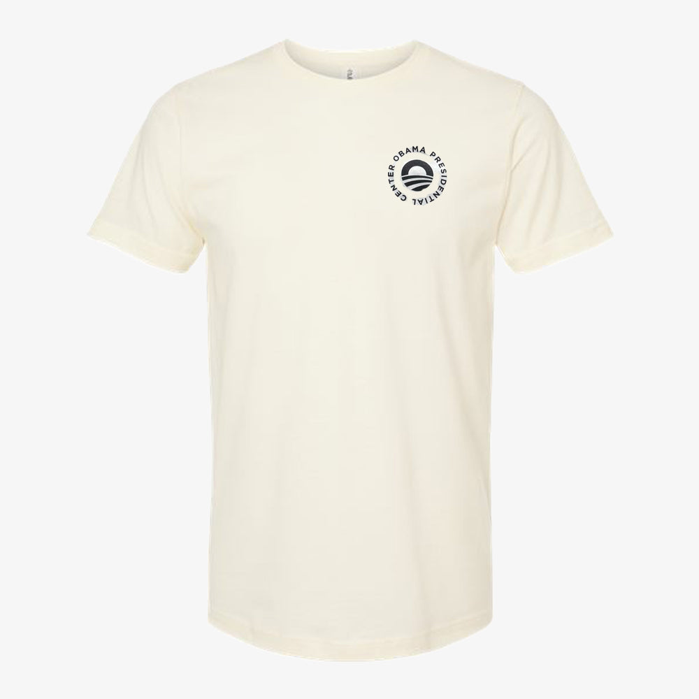 Ecru Obama Presidential Center Script T-shirt featuring a small circular logo with a stylized black “O” on the left chest, celebrating Chicago South Side pride.