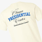 Introducing the Obama Presidential Center Script T-shirt in ecru, featuring bold black and blue text on the back—“Obama Presidential Center, EST. 2026, 601 S Stony Island Ave Chicago 60637, Inspire Empower & Connect”—celebrating the essence of the Obama Foundation’s vision on Chicago’s vibrant South Side.
