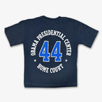 The Obama Presidential Center Home Court T-shirt - Denim features "Obama Presidential Center" and a bold white and blue number 44 on the back—a standout piece for any Obama Foundation collection.