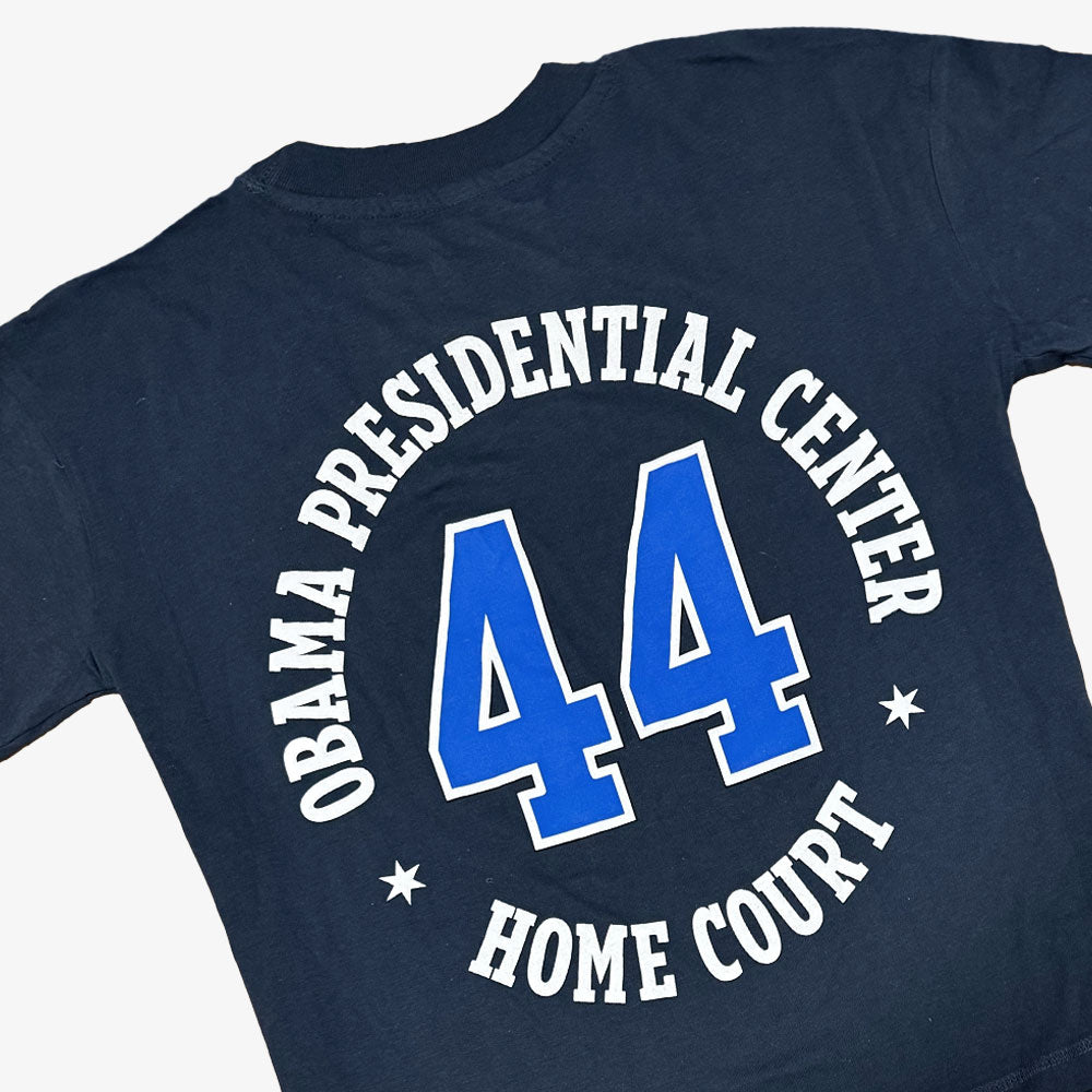A denim Obama Presidential Center Home Court T-shirt with OBAMA PRESIDENTIAL CENTER HOME COURT in white and a large blue and white number 44.