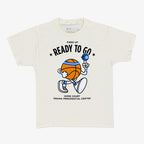 The Obama Presidential Center Home Court Youth T-Shirt is cream-colored and features a cartoon basketball character with a foam finger and microphone, plus the text "Fired Up Ready To Go" and "Home Court Obama Presidential Center.