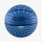 Obama Presidential Center Blue Basketball—kids-size with light blue radiating lines, black stripes, and the Obama Presidential Center logo and text printed in black on the front, part of the exclusive Home Court collection.