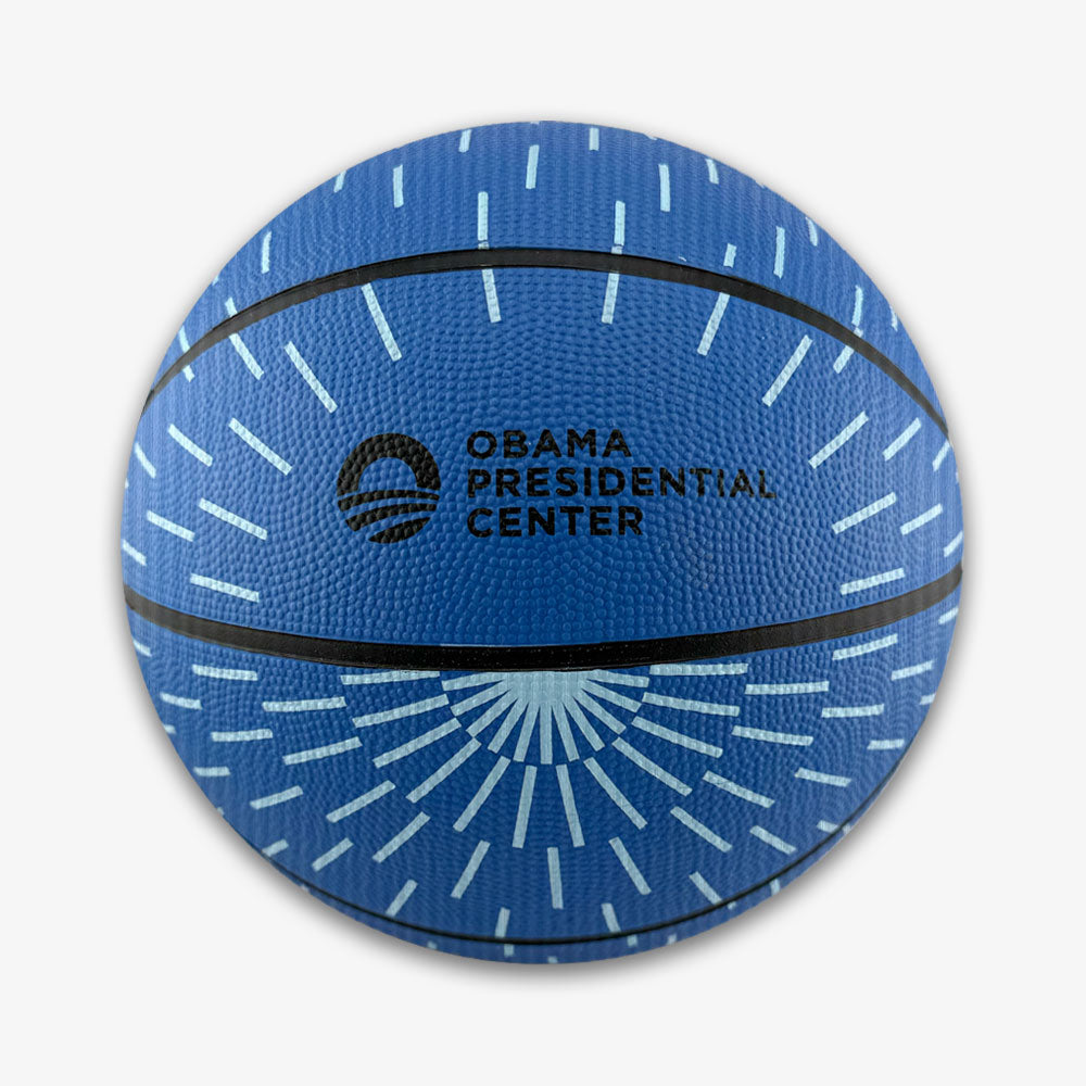 Obama Presidential Center Blue Basketball—kids-size with light blue radiating lines, black stripes, and the Obama Presidential Center logo and text printed in black on the front, part of the exclusive Home Court collection.
