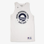 The Obama Presidential Center Home Court Jersey by Champion is a white basketball jersey featuring "Obama Presidential Center Home Court" and a stylized O logo on the front, plus small Champion logos on the chest and hem.