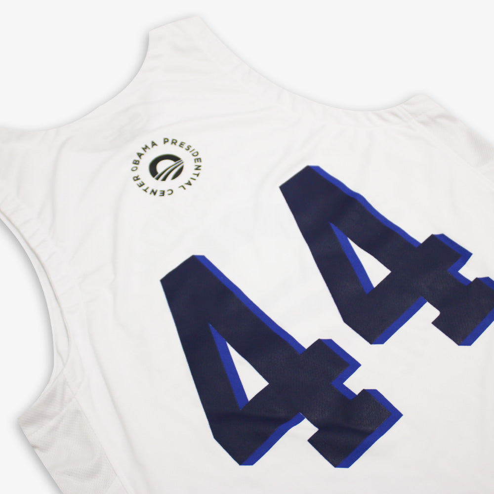 The Obama Presidential Center Home Court Jersey is white with bold blue and black number 44 on the back and features the Obama Presidential Center logo near the collar.