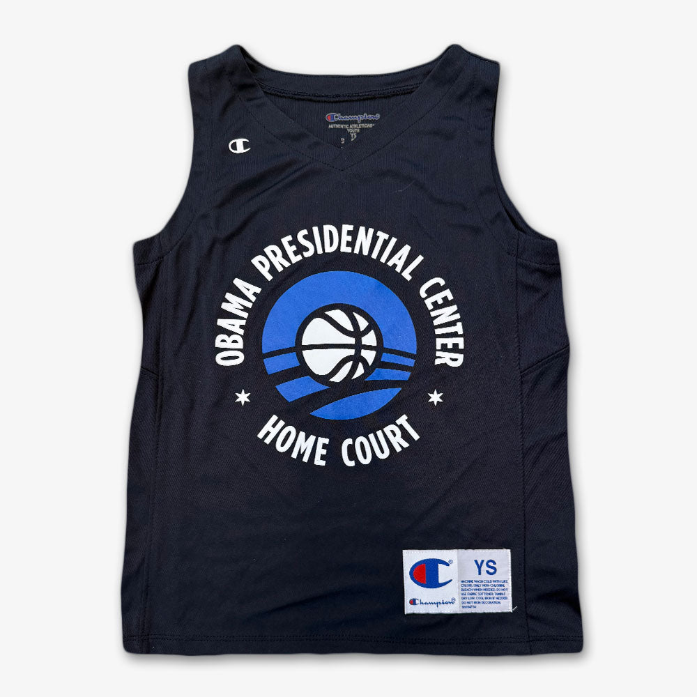The Obama Presidential Center Home Court Youth Jersey is a navy blue Champion jersey featuring a basketball and Home Court graphic on the front.