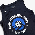 Obama Presidential Center Home Court Youth Jersey in navy blue, featuring "Obama Presidential Center Home Court" encircling a basketball graphic with blue curved lines and a Champion logo on the left shoulder.