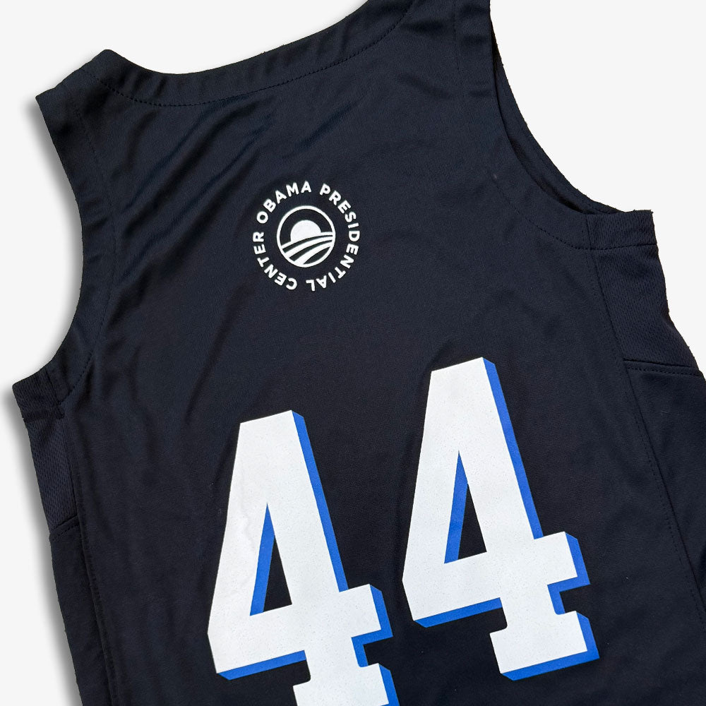 The Obama Presidential Center Home Court Youth Jersey is a black sleeveless jersey with "44" in bold white and blue print and a circular "Obama Presidential Center" logo above the number.