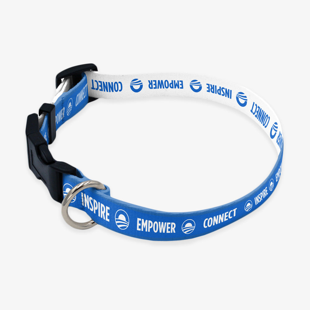 The Obama Presidential Center Pet Collar is blue and white, adjustable, with a black buckle, metal ring, the Obama campaign logo, and the words INSPIRE, EMPOWER, CONNECT— inspired by the Obama Foundation.