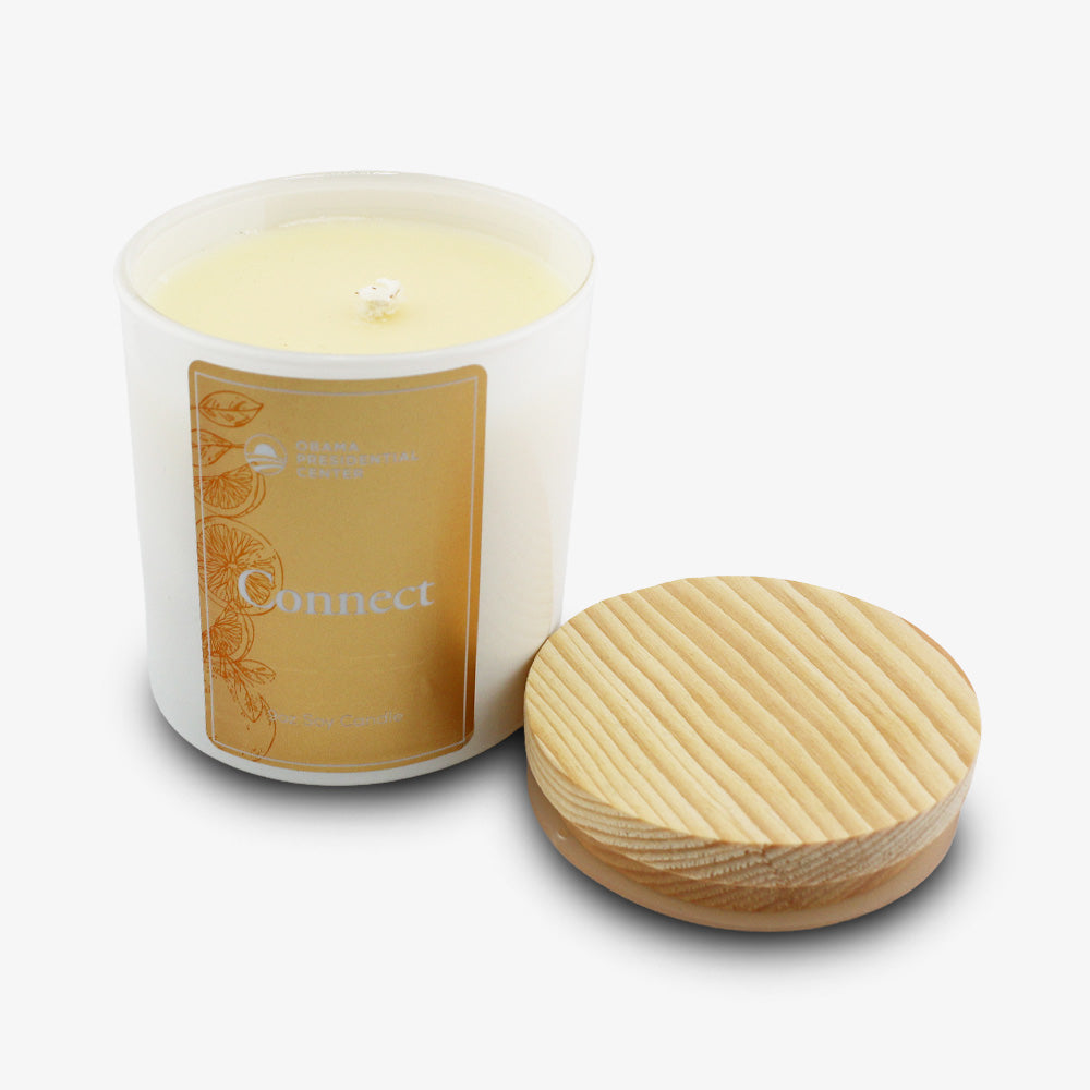 A Connect Sprig Candle 9 oz. in a glass jar labeled Connect, with a wooden lid beside it, on a white background.