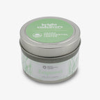 A 4 oz. Empower Sprig Candle in a small silver tin with a green lid, labeled “bright endeavors” and “OBAMA PRESIDENTIAL CENTER.” Hand-poured with plant artwork, made in collaboration with the Obama Foundation.