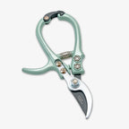 The Gardening Pruners feature a light green handle, durable bypass blade, curved stainless steel edge, and spring mechanism, shown on a plain white background.