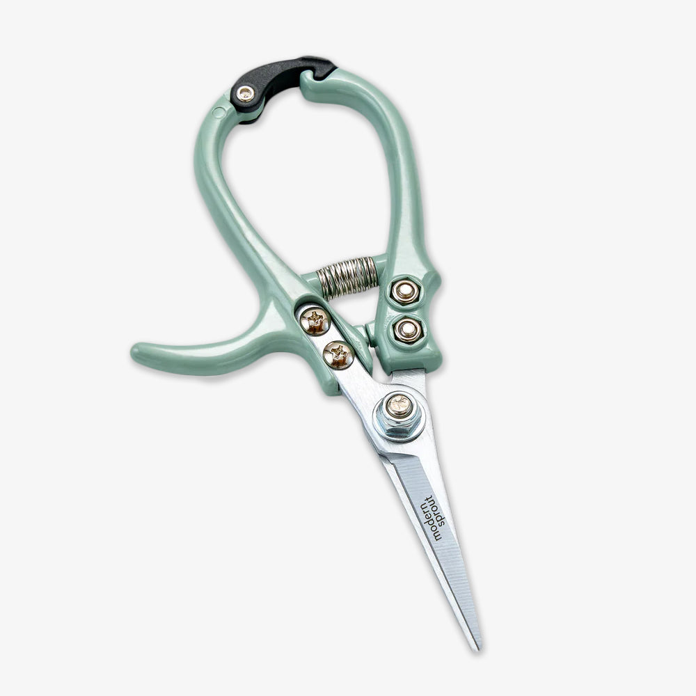The Gardening Shears, featuring mint green handles, high carbon steel blades, a metal spring, and a curved handle, are displayed against a plain white background.