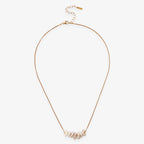 The Gold Pearl Chip Necklace features elegantly irregular white pearls on a gold-plated sterling silver chain, complete with an adjustable clasp and extender for the perfect fit.