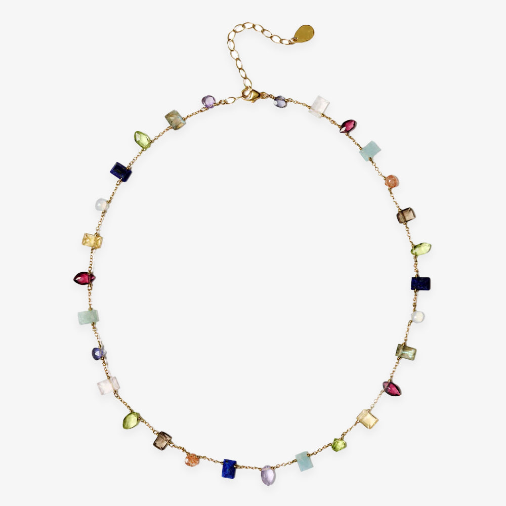 The Gemstone Mix Necklace features a gold chain with assorted semi-precious gemstones in various shapes and sizes, spaced throughout. Inspired by Chan Luu, it includes an adjustable clasp and extender for the perfect fit.