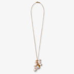 The White Pearl Necklace features a gold chain adorned with a cluster of irregular freshwater pearls and an elegant gold fish charm as its pendant.