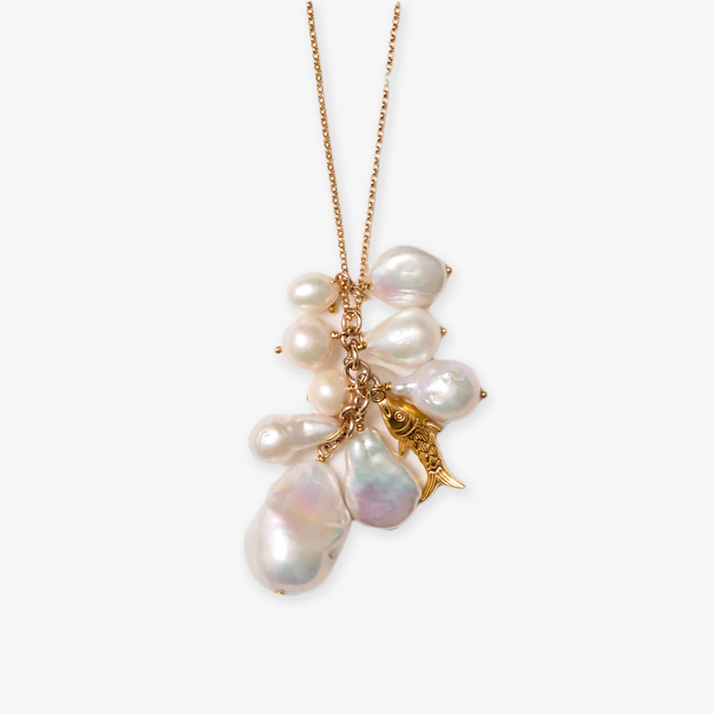 The White Pearl Necklace showcases a gold fish charm among clustered freshwater pearls on a gold chain, set against a white background.