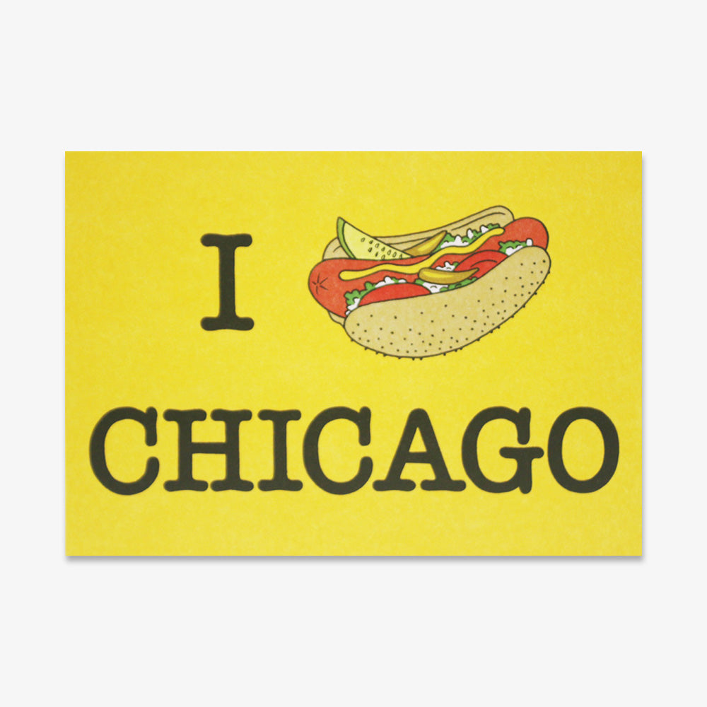 The Chicago Hot Dog Postcard features a yellow sign with “I [Chicago style hot dog] CHICAGO,” where the hot dog illustration replaces "love." A unique and fun Chicago souvenir to display or send as a postcard.