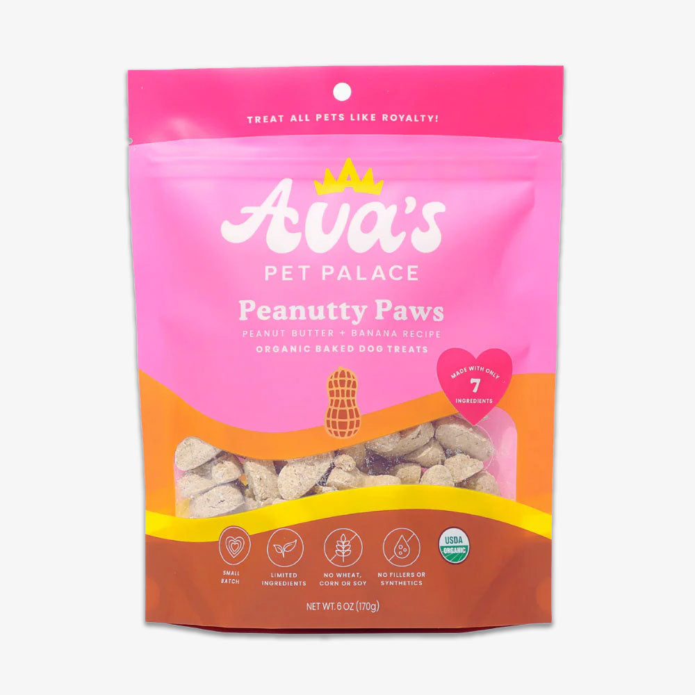 A pink and orange bag of Peanutty Paws Organic Baked Dog Treats with peanut butter and banana flavor, illustrated front, and icons for USDA Certified Organic, limited ingredients, and product details.