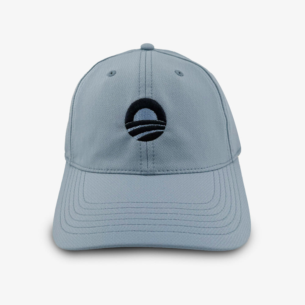 Slate performance golf cap featuring a black and white circular Obama Foundation logo with a rising sun and stripes on the front—official Obama Presidential Center design—displayed against a plain white background.