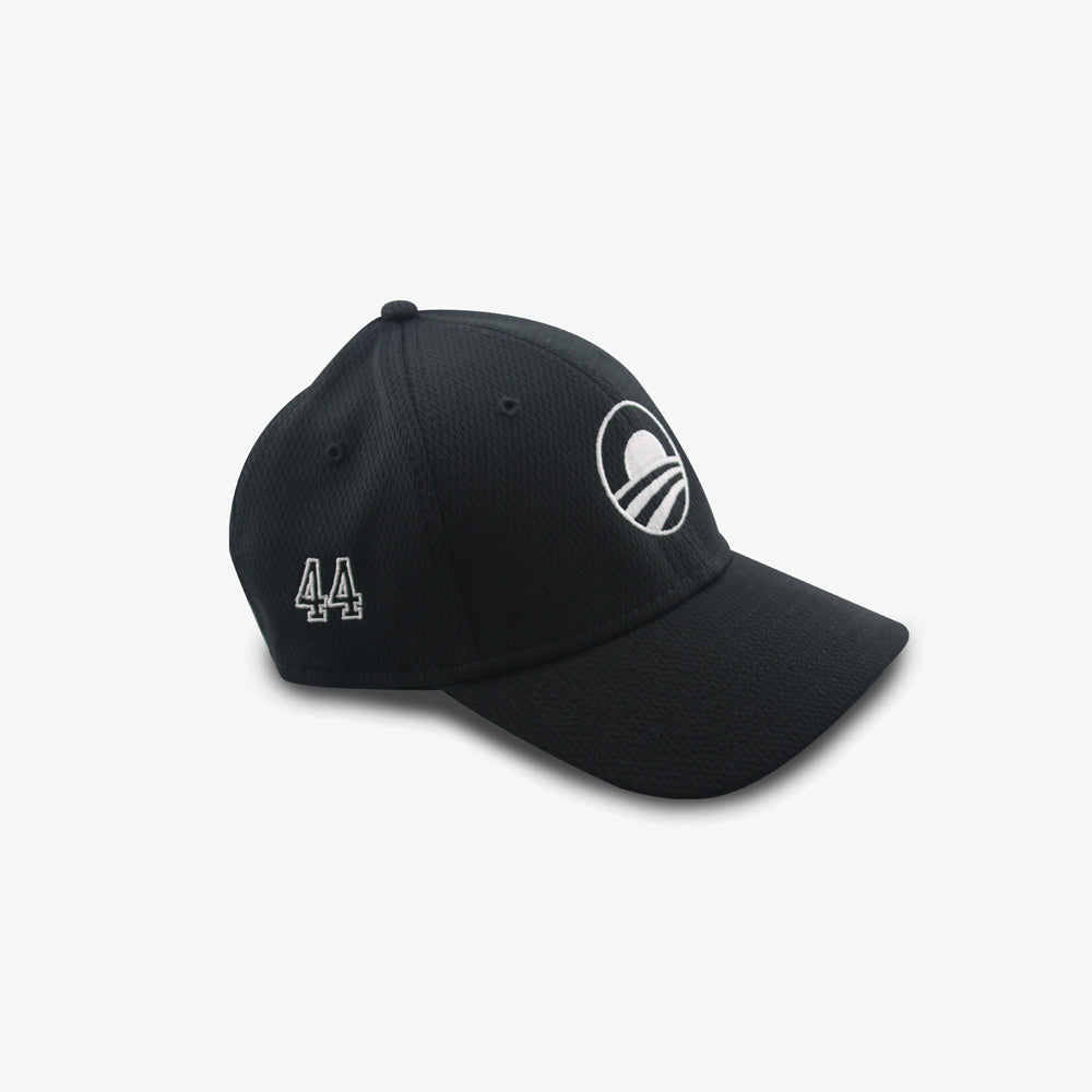 The Obama Presidential Center New Era Symbol Cap is a black baseball cap featuring a white embroidered rising sun logo over three curved lines, with a curved brim and visible stitching—perfect for fans of the Center's iconic style.