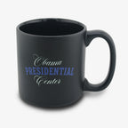 The Obama Presidential Center Script Mug is a matte black ceramic mug featuring "Obama Presidential Center" in white and blue script—an ideal choice for supporters of the Obama Foundation.