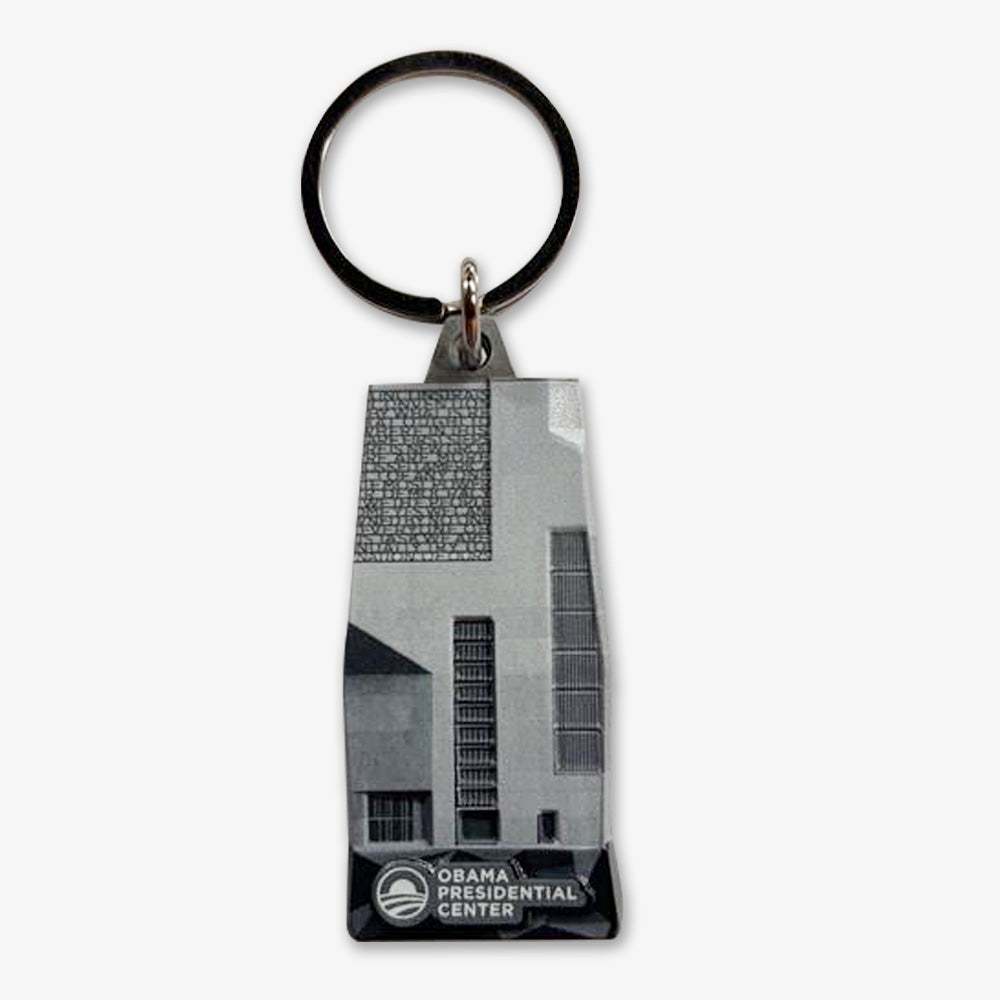 The Obama Presidential Center Building Keychain features a grayscale illustration of the center’s building, complete with its logo and name—an ideal keepsake to add to your presidential collection.