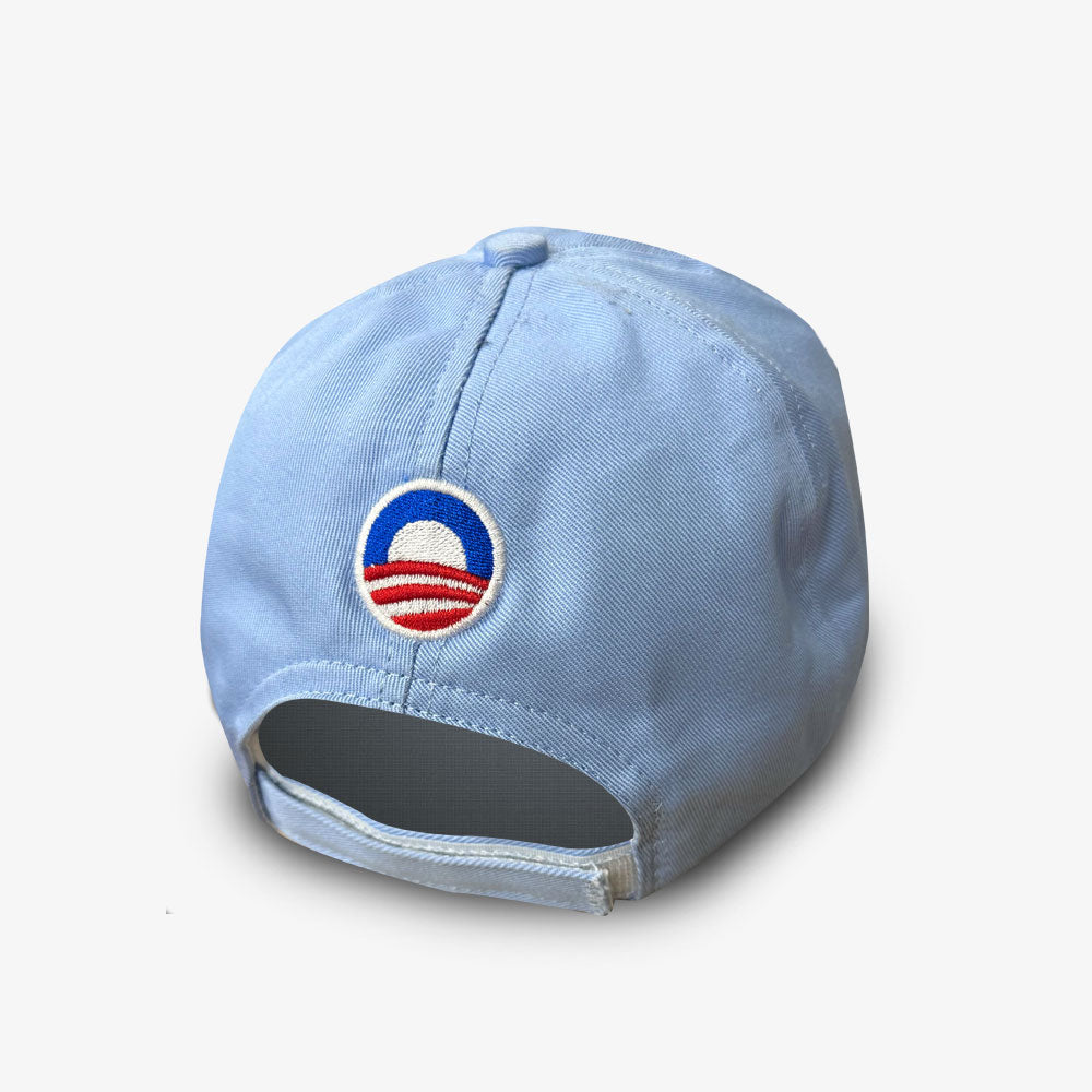 The Official Obama 2008 Campaign Hat in light blue features an embroidered Obama campaign logo above the adjustable strap at the back—a great piece of campaign memorabilia.