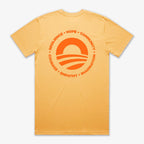 The Obama Presidential Center Hope to Action T-shirt - Sunset features a yellow design with a circular orange sun-over-waves graphic and inspiring words: RESILIENCE • HOPE • COMMUNITY • COURAGE • EMPATHY • IMAGINATION.