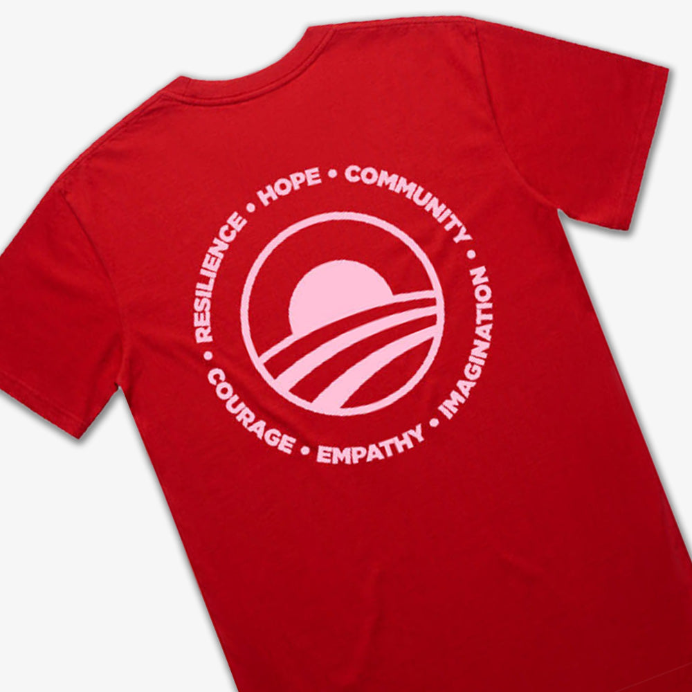 The Obama Presidential Center Hope to Action T-shirt – Sunset features a red design with a white circular logo and the words RESILIENCE, HOPE, COMMUNITY, COURAGE, EMPATHY, and IMAGINATION from the Obama Foundation.
