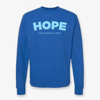 The Obama Presidential Center Hope Sweatshirt in royal blue features bold light blue “HOPE” lettering and “Obama Presidential Center” below, crafted in a classic crewneck style.