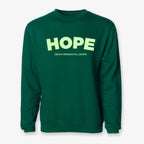 The Obama Presidential Center Hope Sweatshirt - Green features "HOPE" in large yellow letters and "OBAMA PRESIDENTIAL CENTER" in smaller yellow text on the front.
