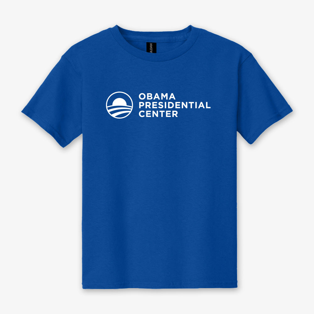 Showcased on a simple, light background, the Obama Presidential Center Logo Youth T-Shirt - Royal is a comfortable blue unisex youth tee featuring white Obama Presidential Center text and logo on the chest. This standout t-shirt is part of the official Obama Foundation collection.