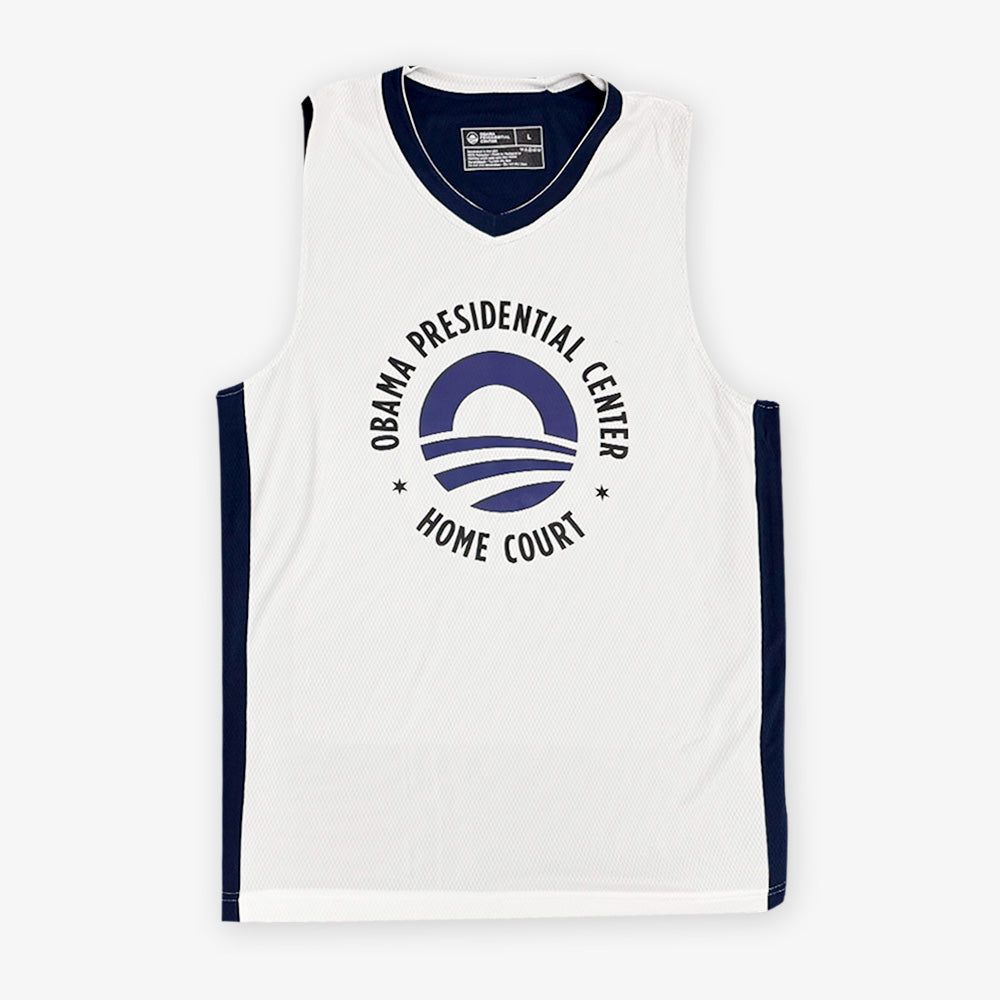 The Obama Presidential Center Home Court Jersey - White features navy trim, the Obama Foundation logo, and "OBAMA PRESIDENTIAL CENTER HOME COURT" printed on the front in navy blue.
