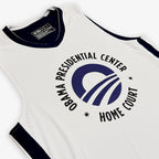 The Obama Presidential Center Home Court Jersey - White features navy trim and a circular "Obama Presidential Center Home Court" logo on the front; part of the exclusive Home Court collection.